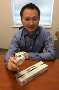 Aaron Yao, PhD, with cigarettes being used in the study.