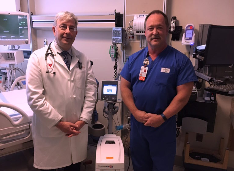 Lawrence W. Gimple, MD, (left) and Mark Adams, nurse manager of UVA's Coronary Care Unit, with the cooling console used in targeted temperature management.