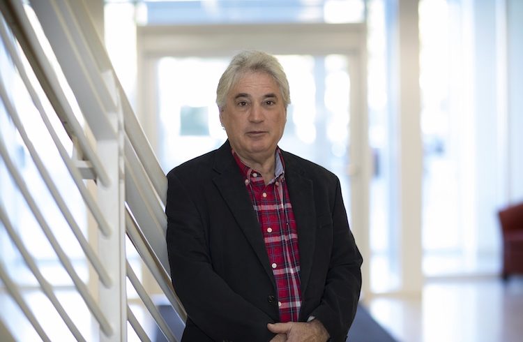 Edward H. Egelman poses in a brightly lit stairwell.