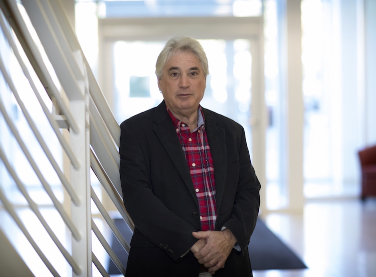 Edward H. Egelman poses in a brightly lit stairwell.