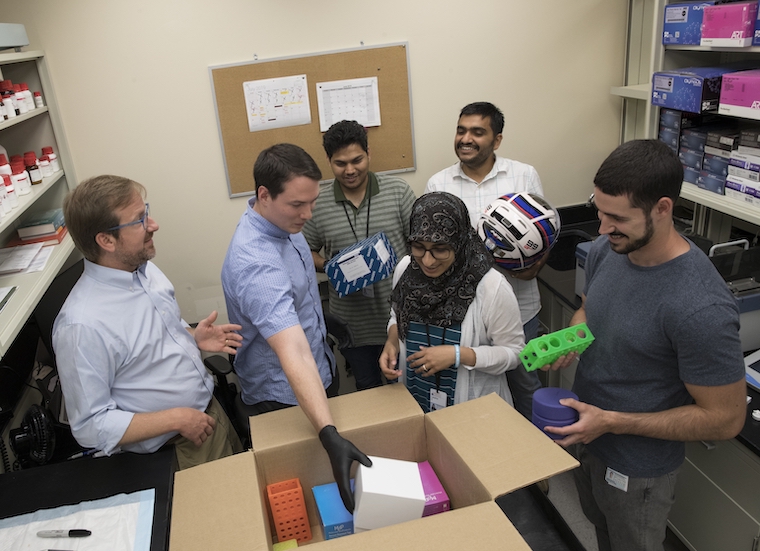 Greg Medlock's work aims to determine how to grow microbes most efficiently. It's similar to figuring out how to most effectively fit many items into a box.