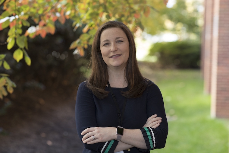 Neonatologist Jennifer Burnsed stands beneath a green tree.