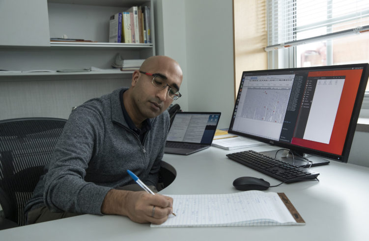 Askrosh Ratan works at his desk.