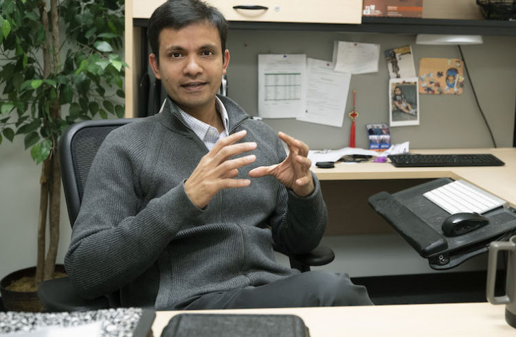 Swapnil Sonkusare gestures at his desk.