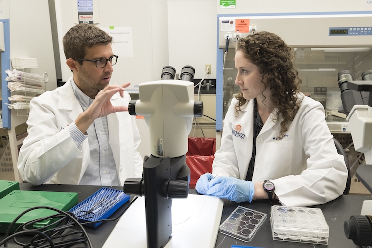 John Lukens talks with Ashley Bolte in the lab.