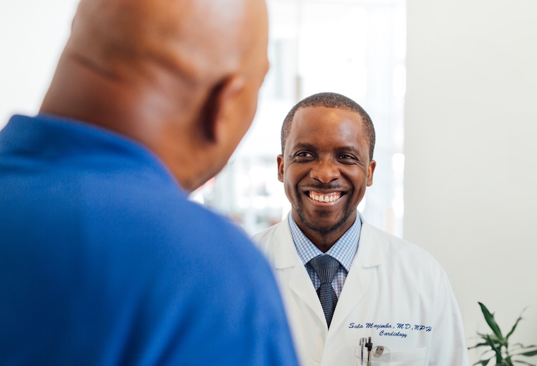 Sula Mazimba visits with a patient.