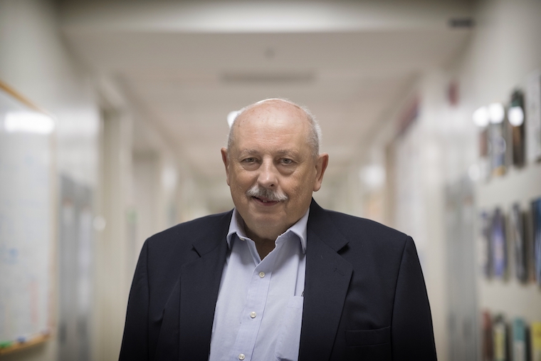 Wladek Minor smiles in the hallway outside his lab.