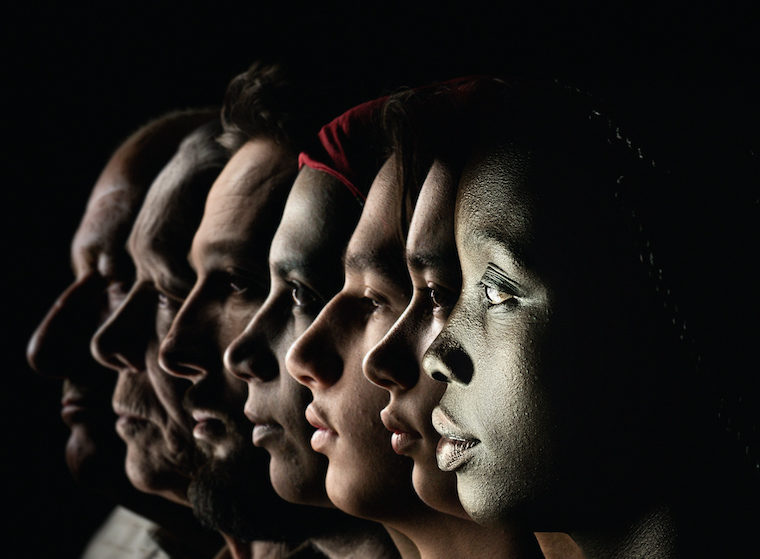 Profiles of the faces of people of different races and places of origins.