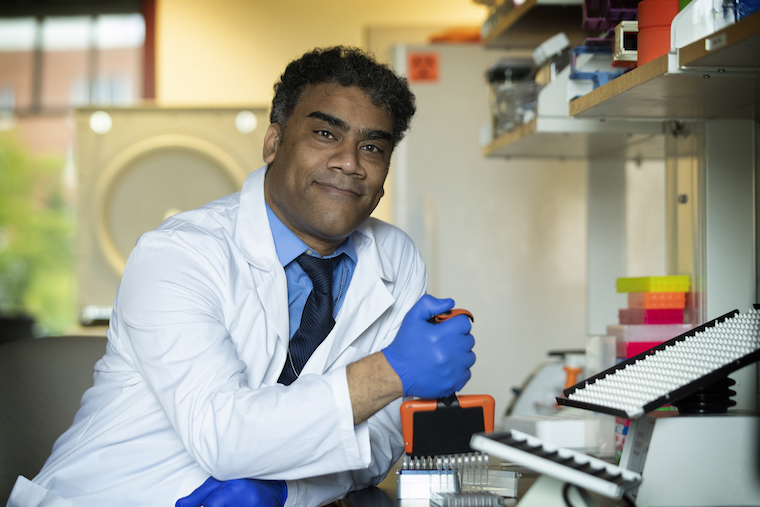 Shannon Moonah works at a bench in his lab.