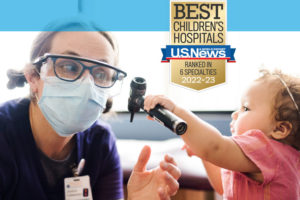 A small child plays with an otoscope used to look in ears. Txt says U.S. News best children's hospitals - ranked in six specialties.