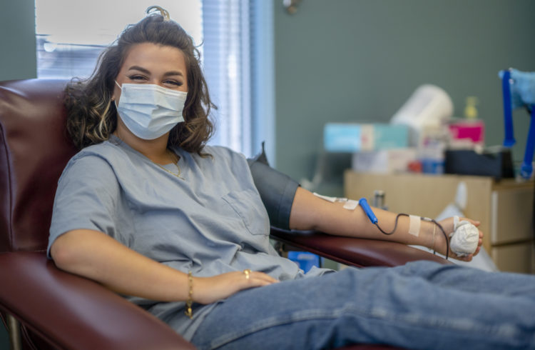 A woman donates blood.