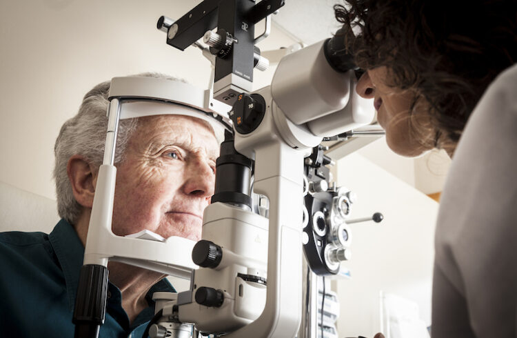 Optometrist examines patient.