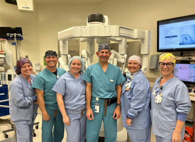 Portrait of robotic-assisted surgery team