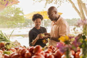 A couple selects produce at a farmers' market