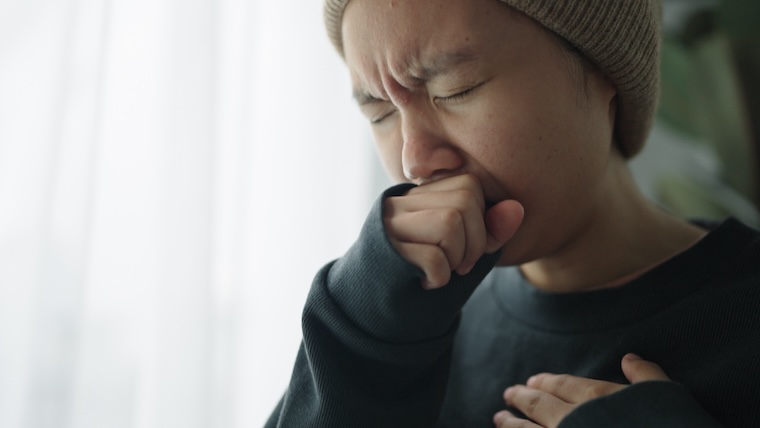 Young woman coughing