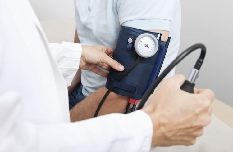 Doctors takes patient's blood pressure