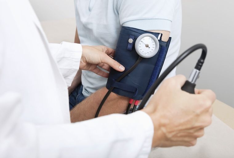 Doctors takes patient's blood pressure