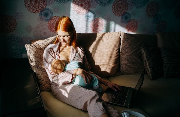 Mother breastfeeding in dimly lit room