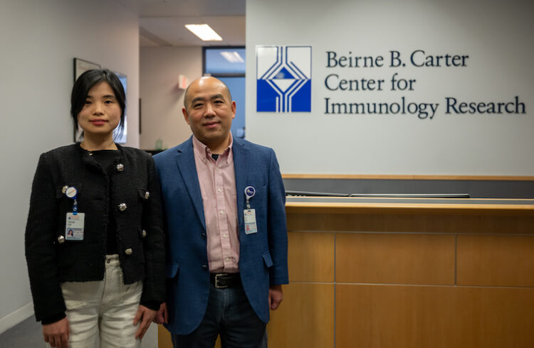 Xiaoqin Wei, PhD, and Jie Sun, PhD, outside UVA's Carter Center for Immunology Research