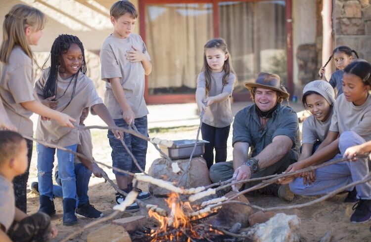 Kids roast marshmallows at summer camp
