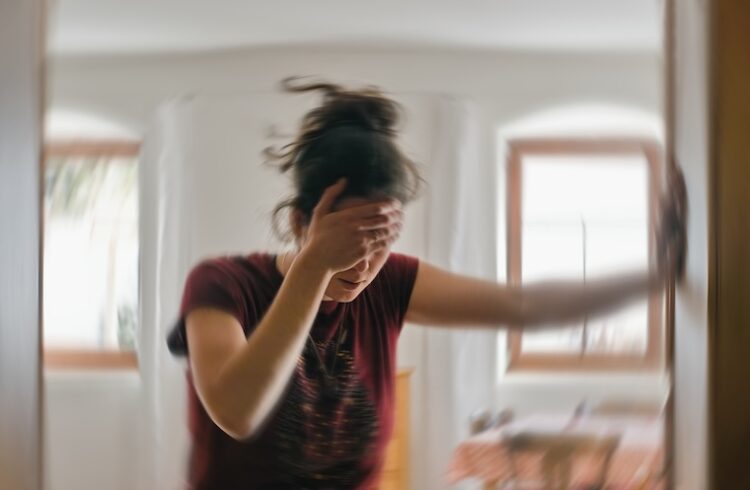 Young woman suffering bout of dizziness, a symptom of POTS.