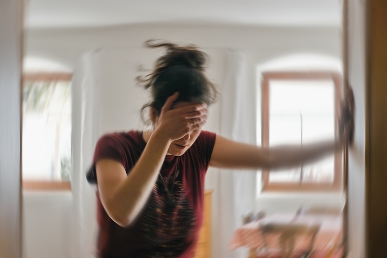 Young woman suffering bout of dizziness, a symptom of POTS.